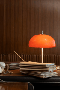 an orange lamp on a desk