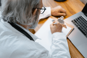 A doctor writing on a paper