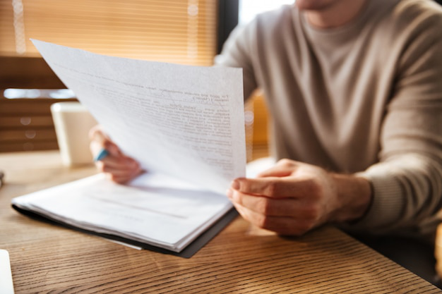 Certified translator reviewing academic transcripts and diplomas at a desk