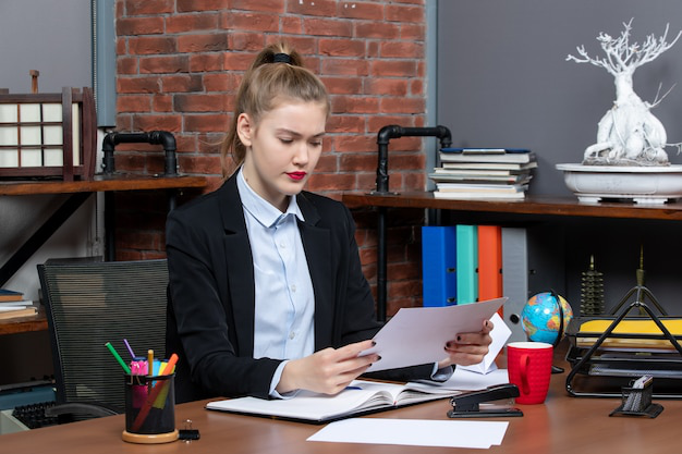 Professional translator referencing files while translating a university transcript