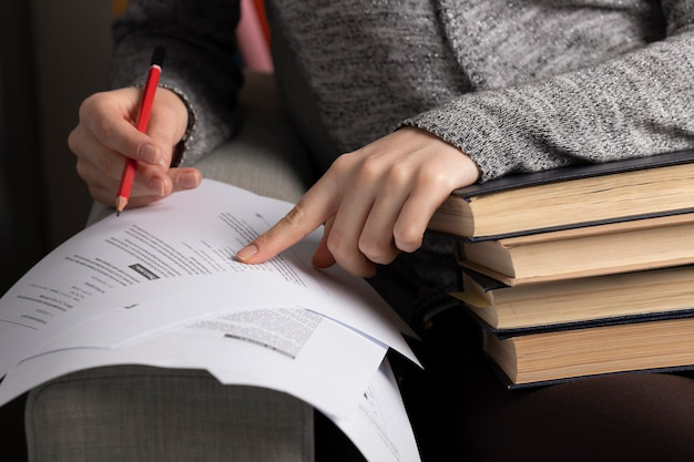 Professional translator using a reference guide to verify official terminology used by universities