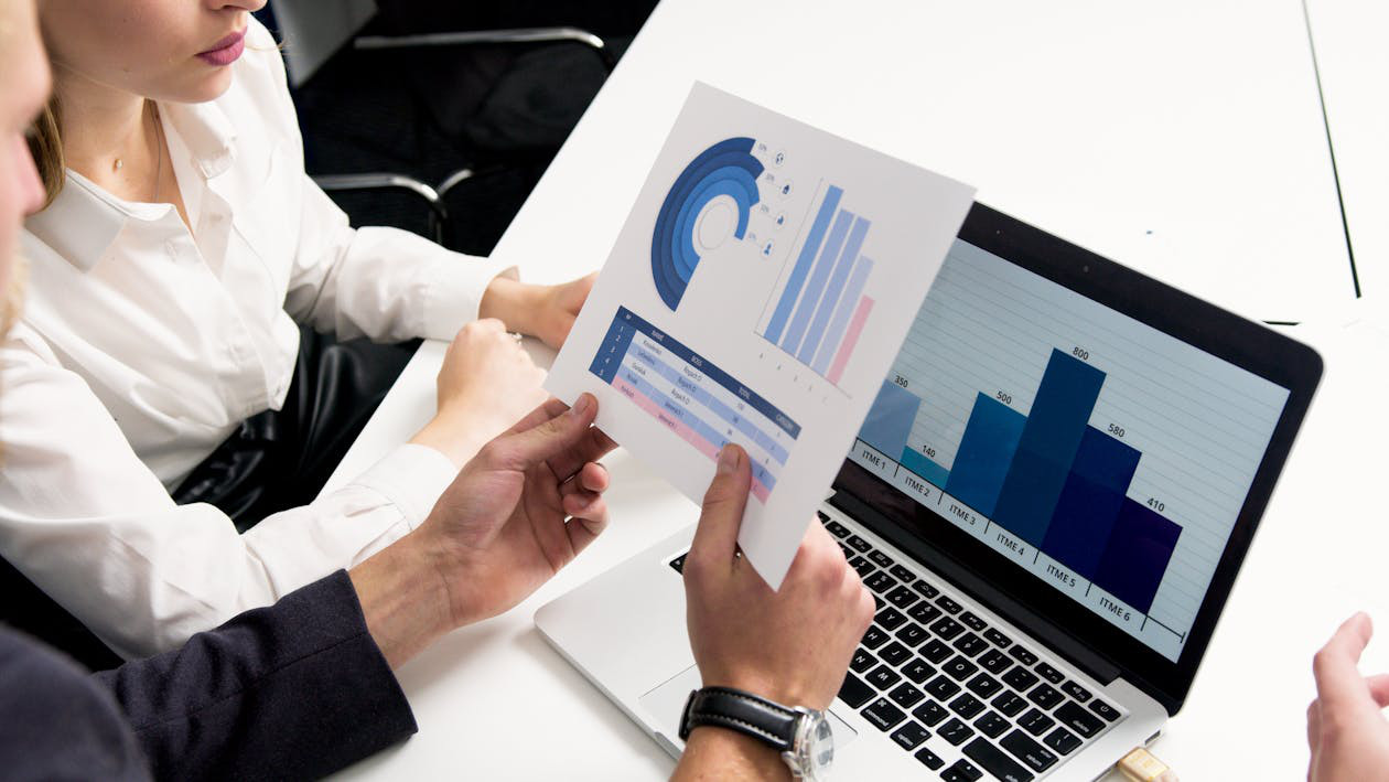 two people looking at a chart.