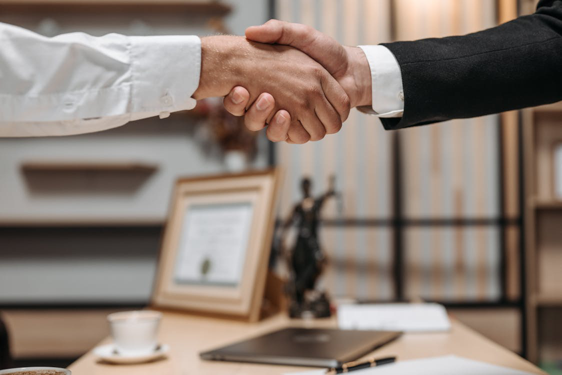 an attorney shaking hands with a client. 