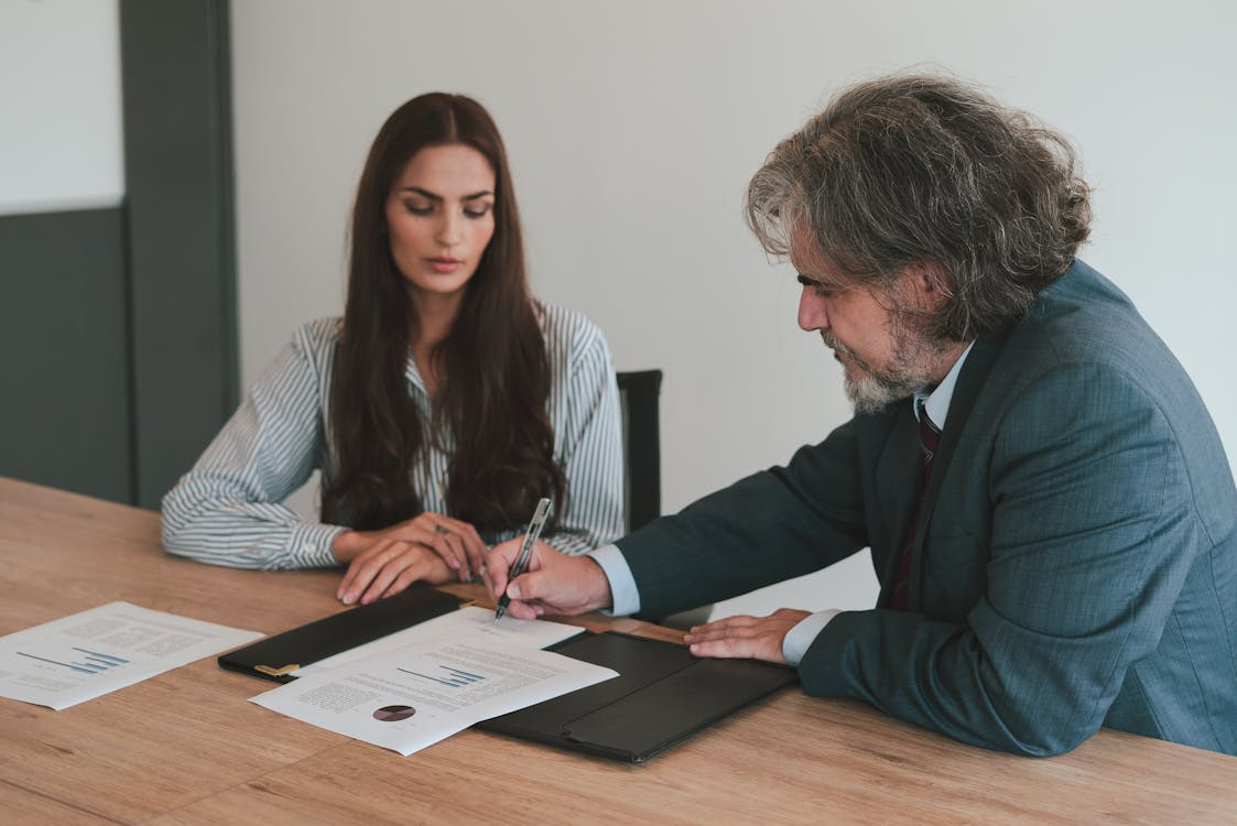 a man signing a document. 