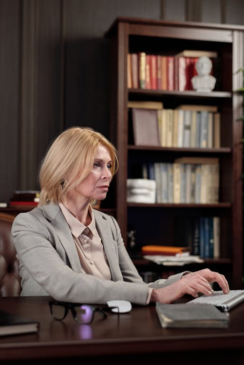 a woman with blonde hair typing.