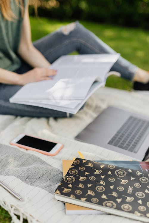 a student studying outdoors.