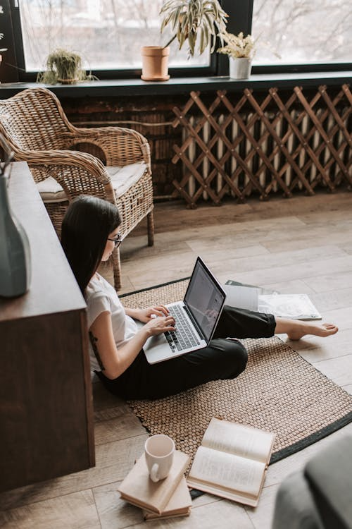 a person sitting on the floor and working