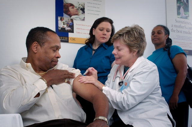 This photo shows a healthcare worker administering a vaccine