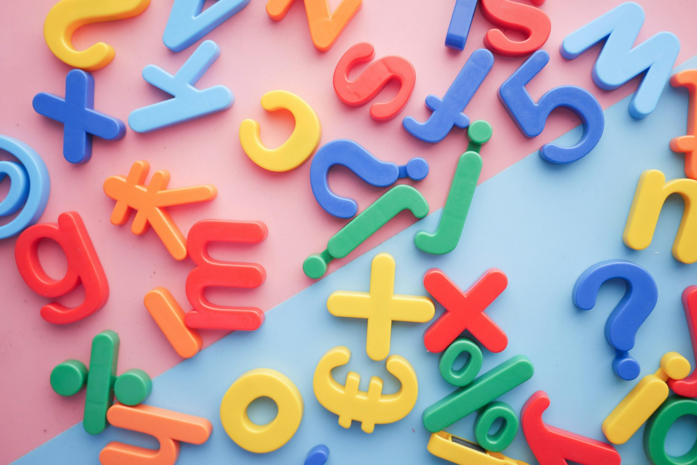 Scattered pieces of letters and symbols