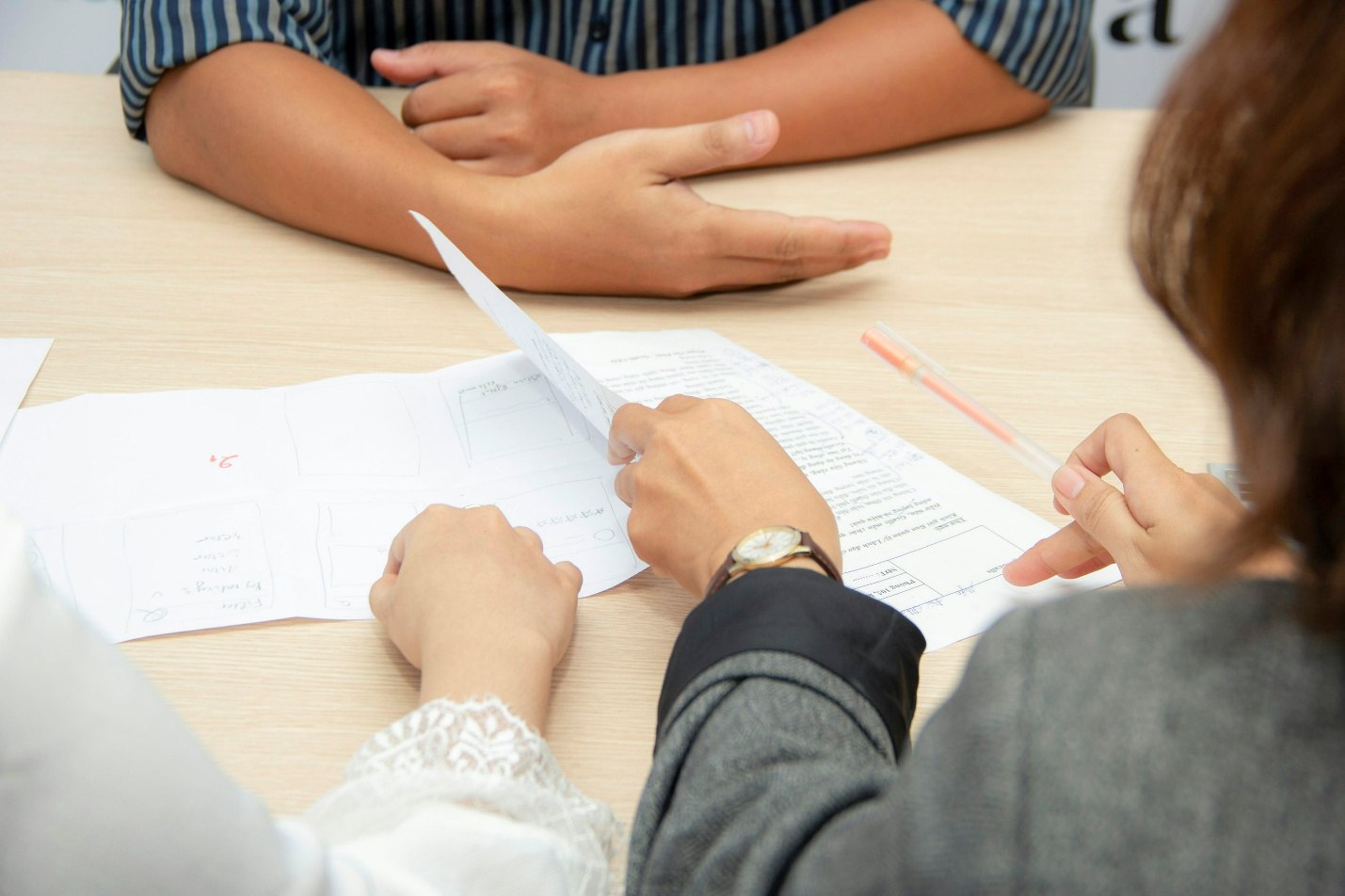 A group of people looking at papers on a table