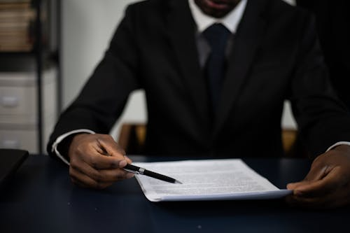  Immigration officer verifying translated police records during visa screening.