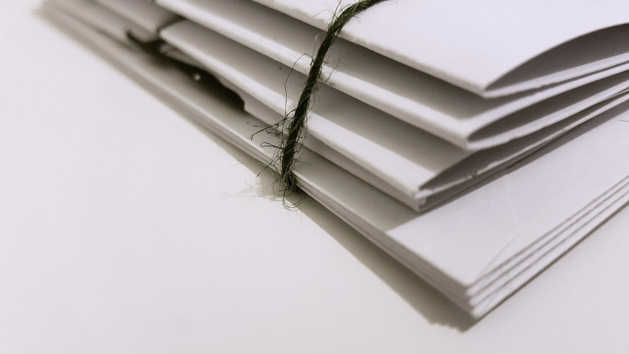 Secured white folders tied with a black string