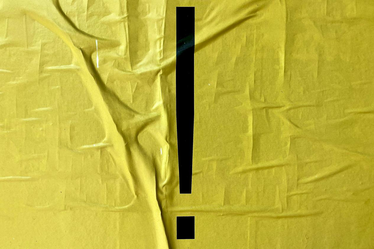 A black exclamation mark on a yellow sign