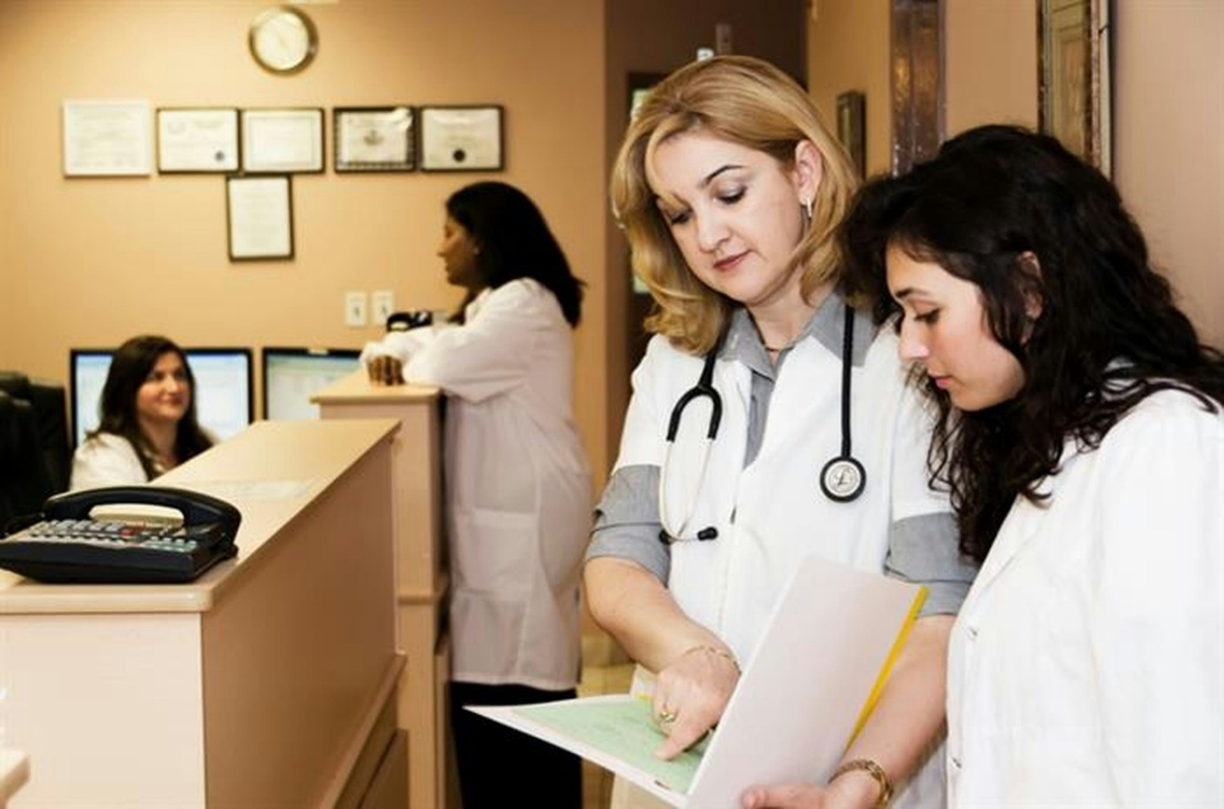 Two doctors holding printed documents.