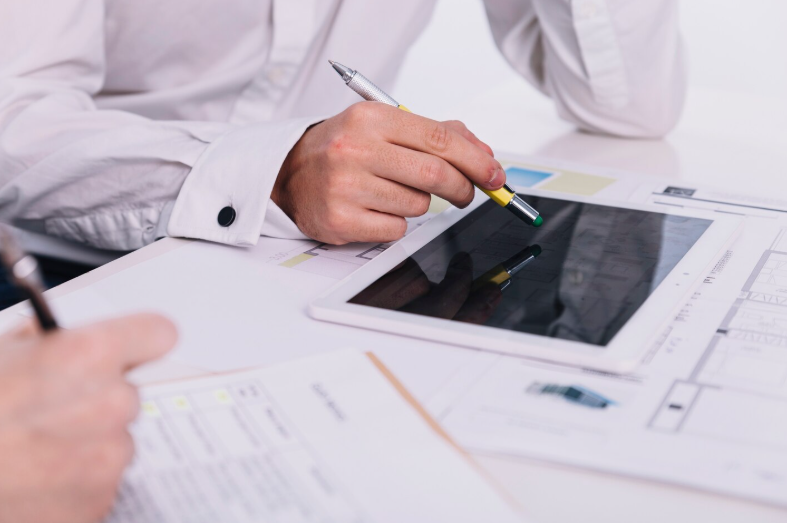 engineer comparing multilingual technical manuals to ensure accuracy and consistency