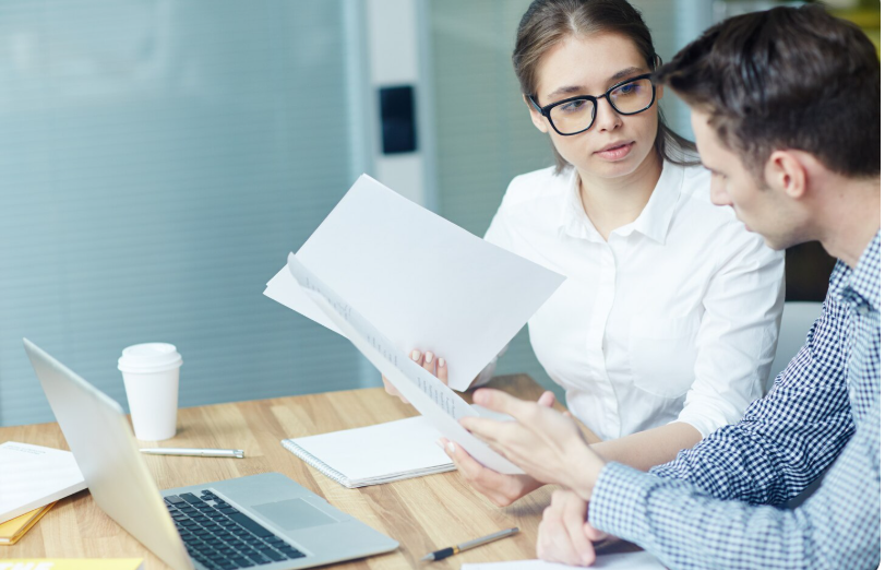 Professional translators discussing a document and collaborating on a translation project