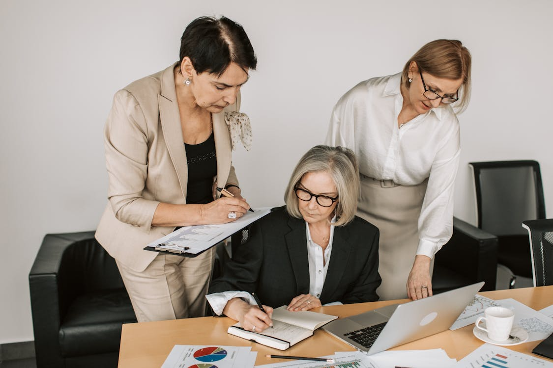 Three women in a work meeting.