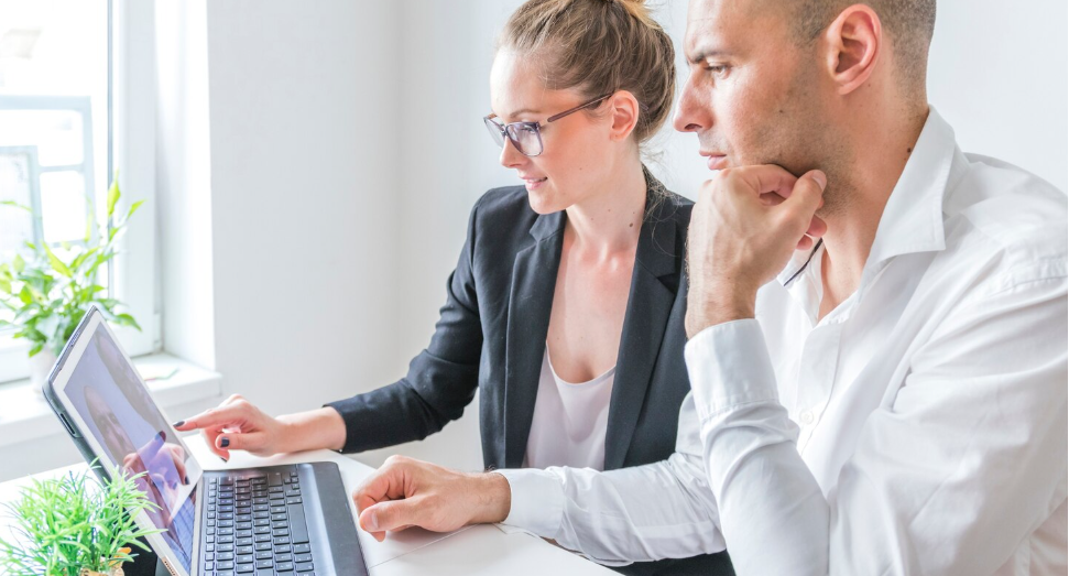 Professional translators validating legal document translation using a laptop