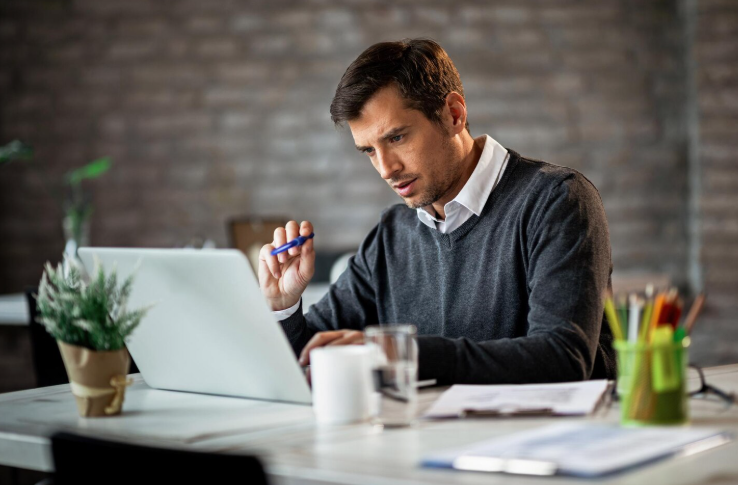 Professional translator reviewing immigration documents on a laptop to prevent rejection